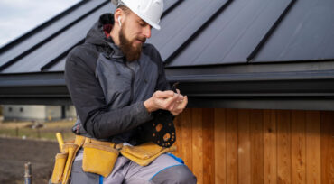 A construction worker in a hard hat holds a tool on his shoulder, symbolizing Titan Exteriors. A construction worker in a hard hat holds a tool on his shoulder, symbolizing Titan Exteriors.