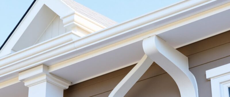 Detailed image of a house roof, highlighting the texture of shingles, featuring Titan Exteriors branding