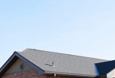 A house featuring a brick roof, showcasing the craftsmanship of Titan Exteriors. A house featuring a brick roof, showcasing the craftsmanship of Titan Exteriors.